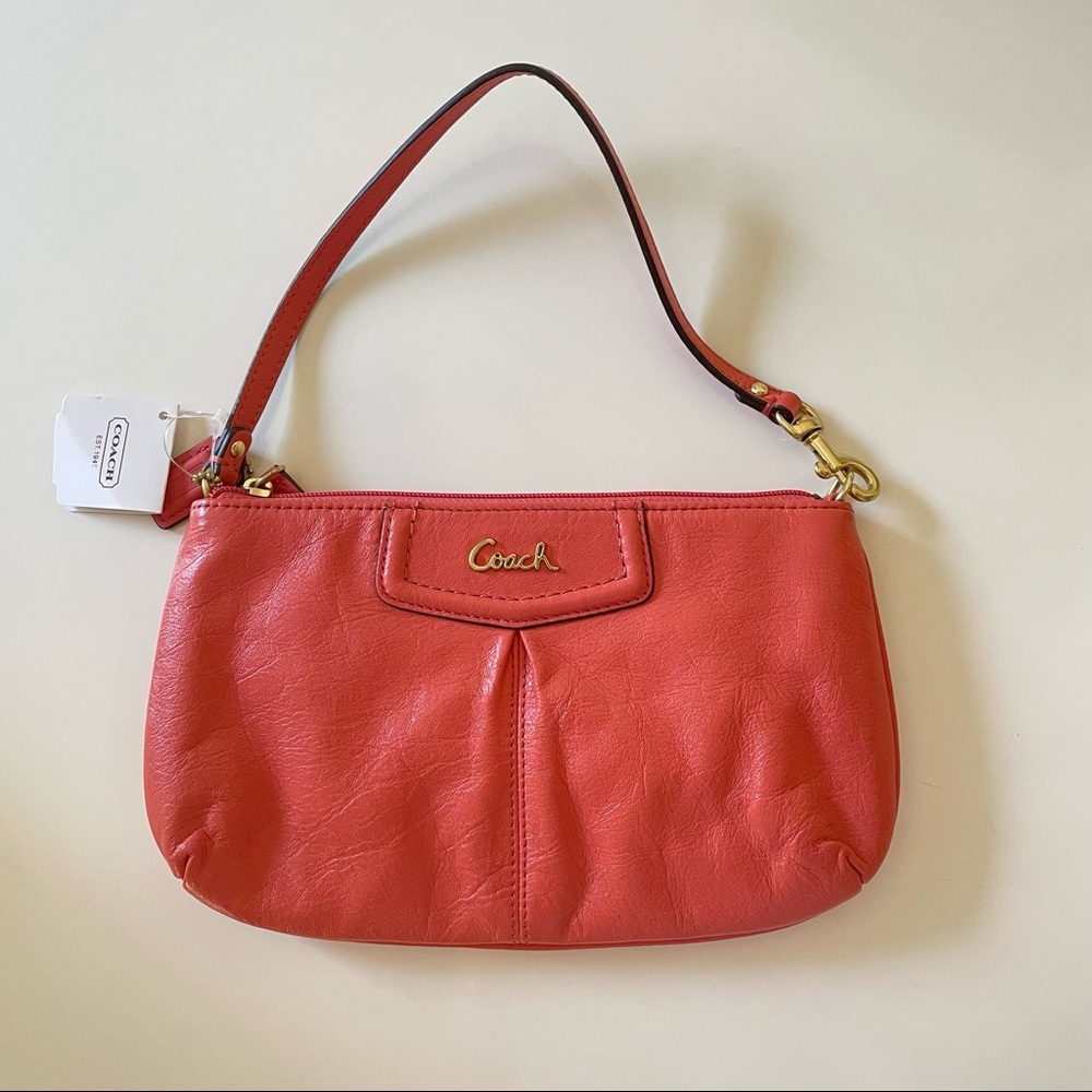 Coach purse / wristlet in coral pink color